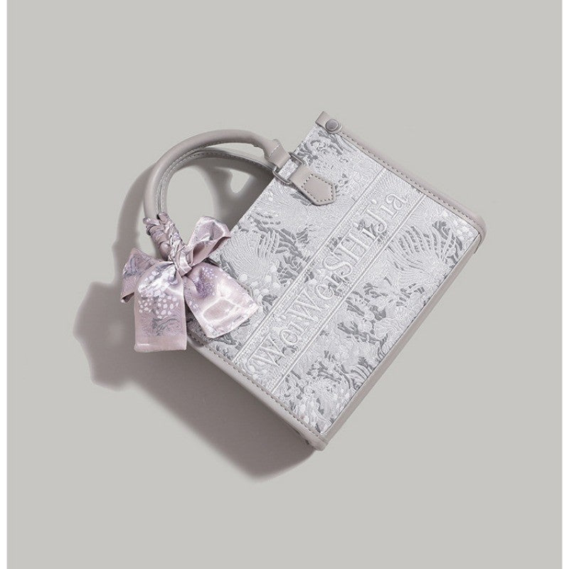 Ielgy Commuter Tote Bag High-End Pattern Embroidery Portable One-Shoulder Diagonal Shopping Bag (Ribbon Style Random Shipping)